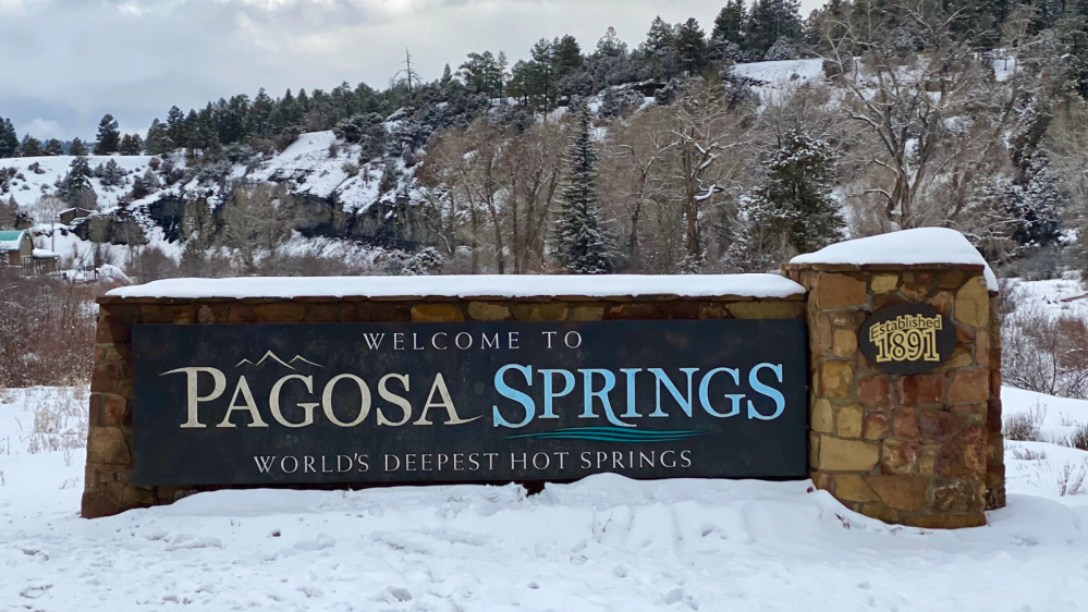 The snow covered welcome to Pagosa Springs sign