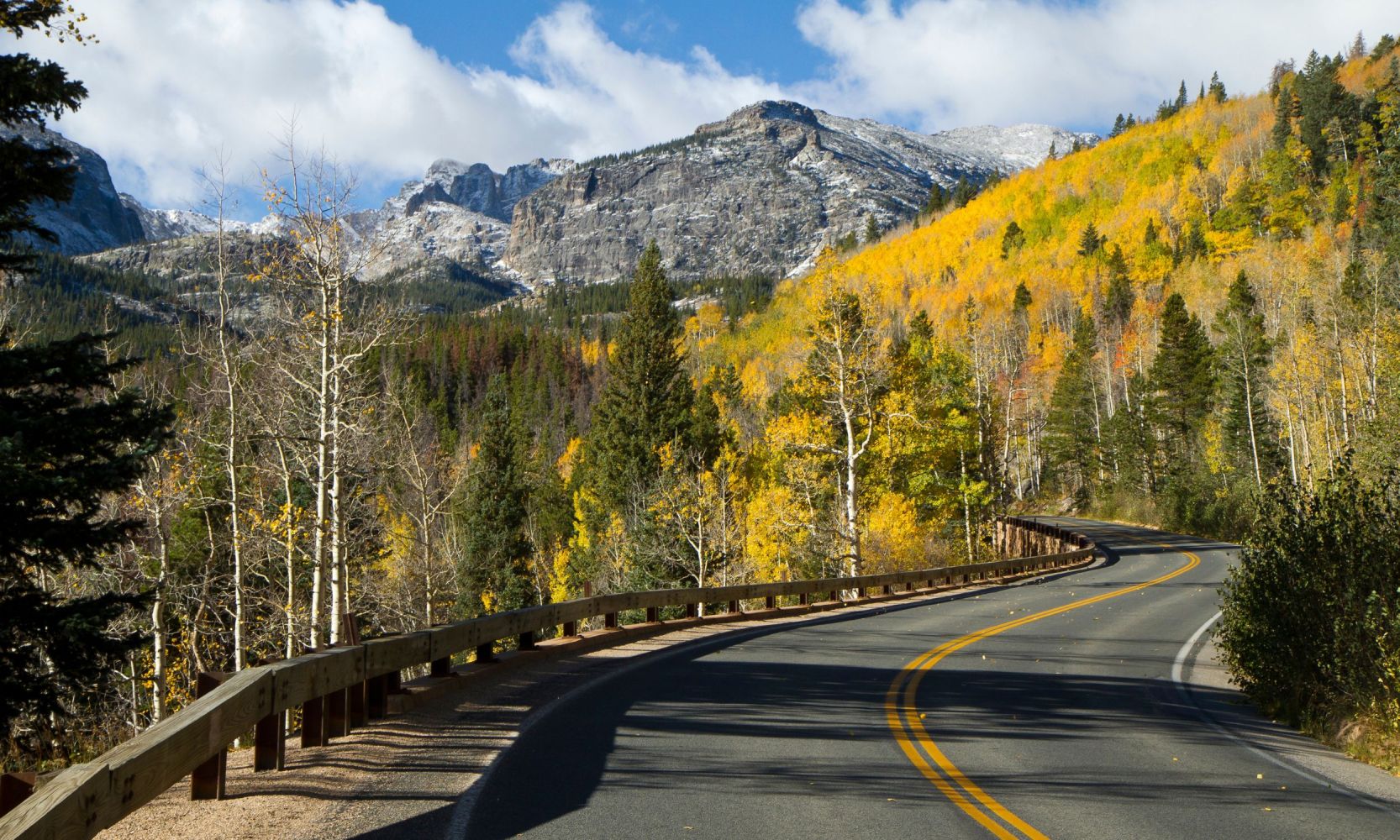 a view of a mountain road with fall foliage in colorado